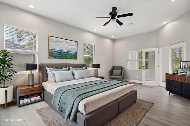 bedroom featuring light wood-style floors, recessed lighting, multiple windows, and visible vents