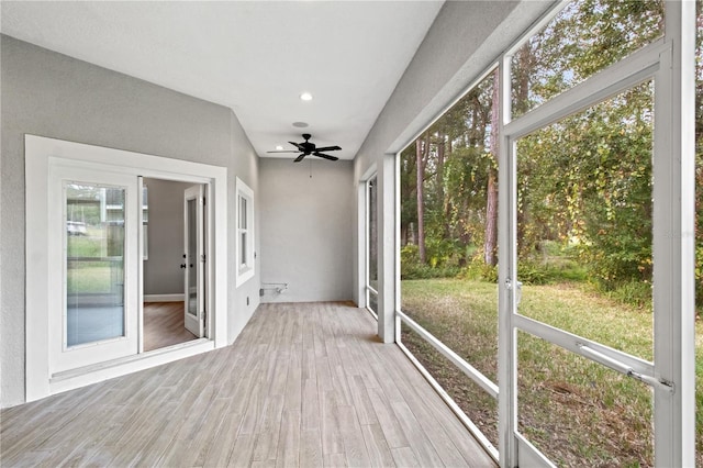 unfurnished sunroom featuring a ceiling fan