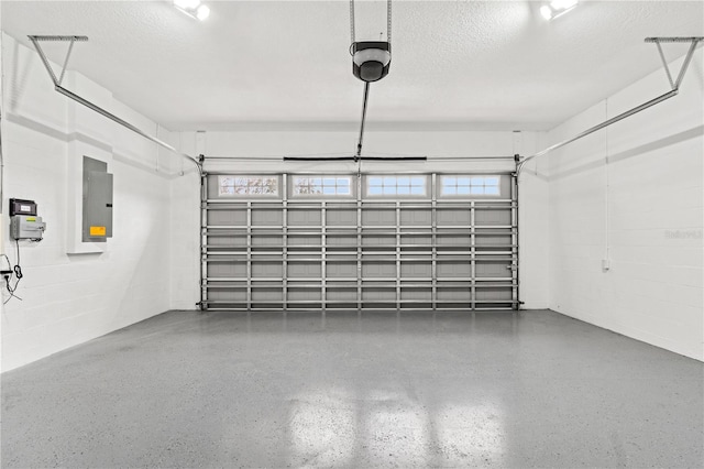 garage featuring concrete block wall and electric panel