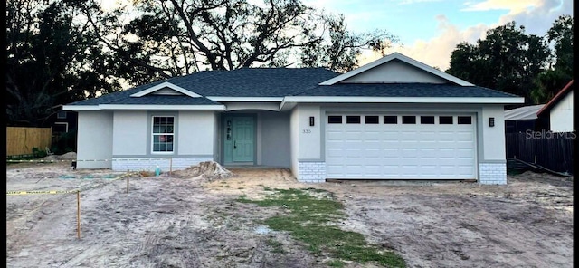 single story home with a garage