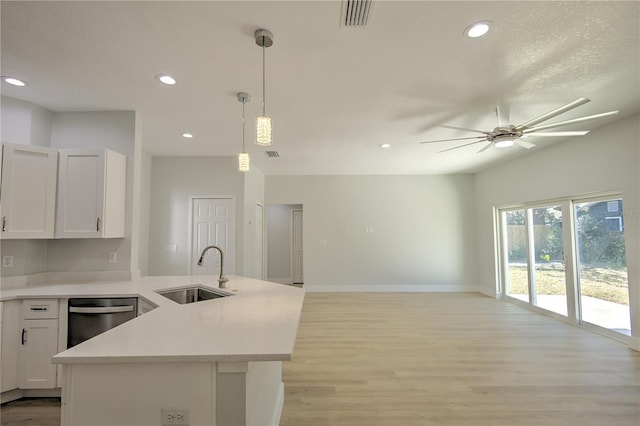 kitchen featuring pendant lighting, white cabinetry, dishwasher, sink, and ceiling fan