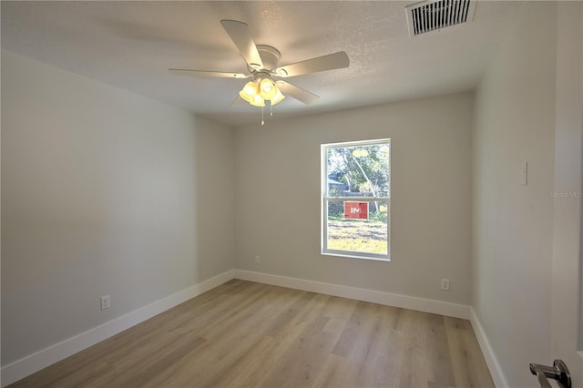 unfurnished room featuring light hardwood / wood-style flooring and ceiling fan