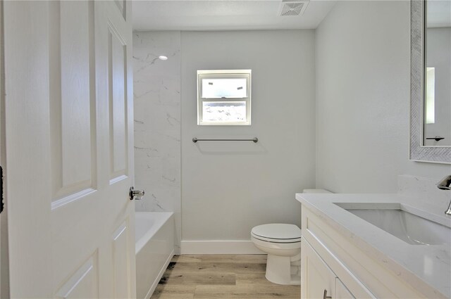 full bathroom with vanity, toilet, hardwood / wood-style floors, and shower / bathing tub combination