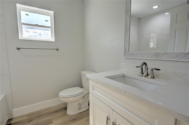 bathroom with vanity, a shower, hardwood / wood-style floors, and toilet