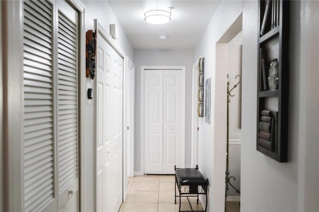 corridor featuring light tile patterned floors