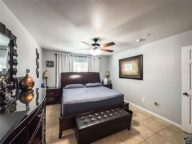 tiled bedroom featuring a textured ceiling and ceiling fan