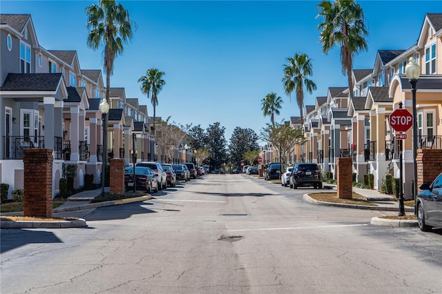 3383 Westchester Square Blvd Unit 202, Orlando, FL 32835 - view of asphalt road featuring a residential view, traffic signs, curbs, and street lighting