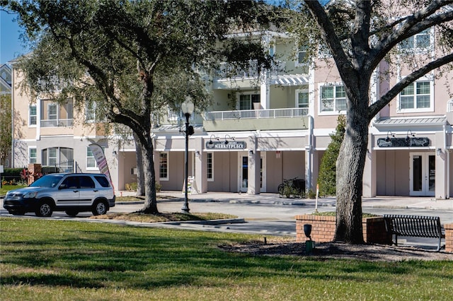 3383 Westchester Square Blvd Unit 202, Orlando, FL 32835 - view of front of home with french doors, stucco siding, and a front yard