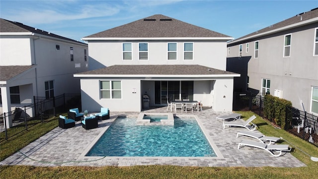 back of house with a pool with hot tub, an outdoor hangout area, and a patio