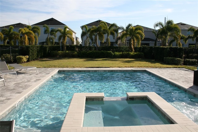 view of swimming pool with an in ground hot tub