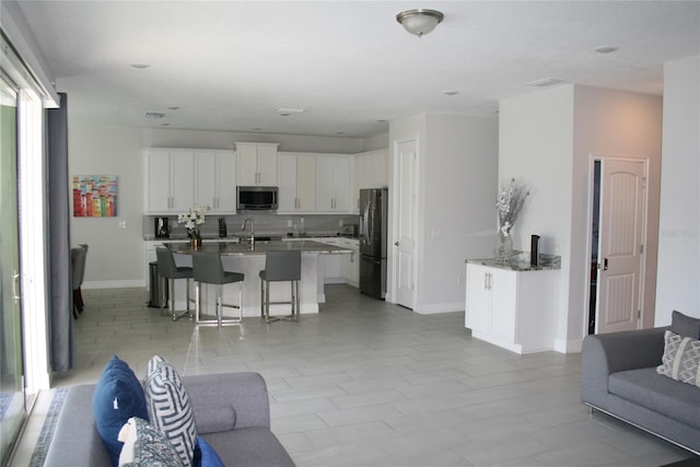 living room featuring sink and a healthy amount of sunlight