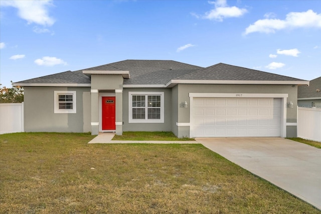 prairie-style home with a front lawn and a garage