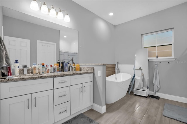 bathroom with hardwood / wood-style flooring, vanity, and independent shower and bath