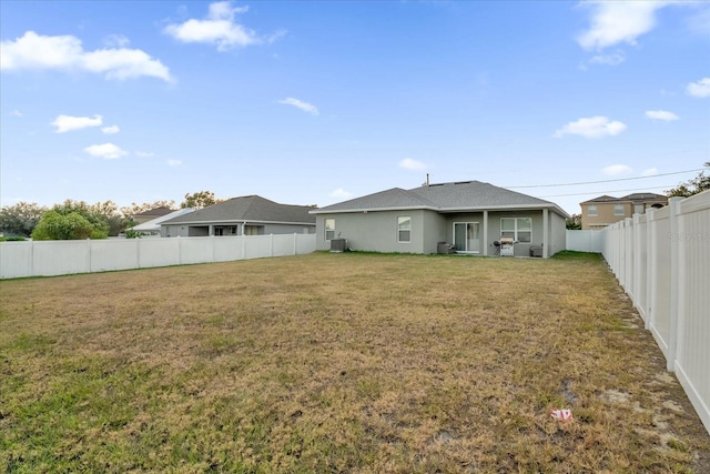 back of house with a lawn and cooling unit