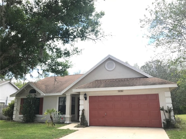 ranch-style home with a front lawn and a garage