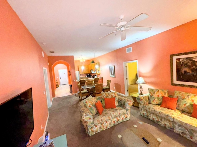 carpeted living room featuring ceiling fan