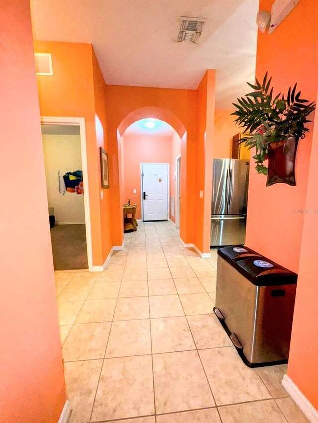 corridor featuring light tile patterned floors