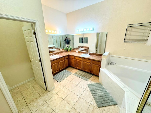 bathroom featuring tile patterned floors, vanity, and a relaxing tiled tub