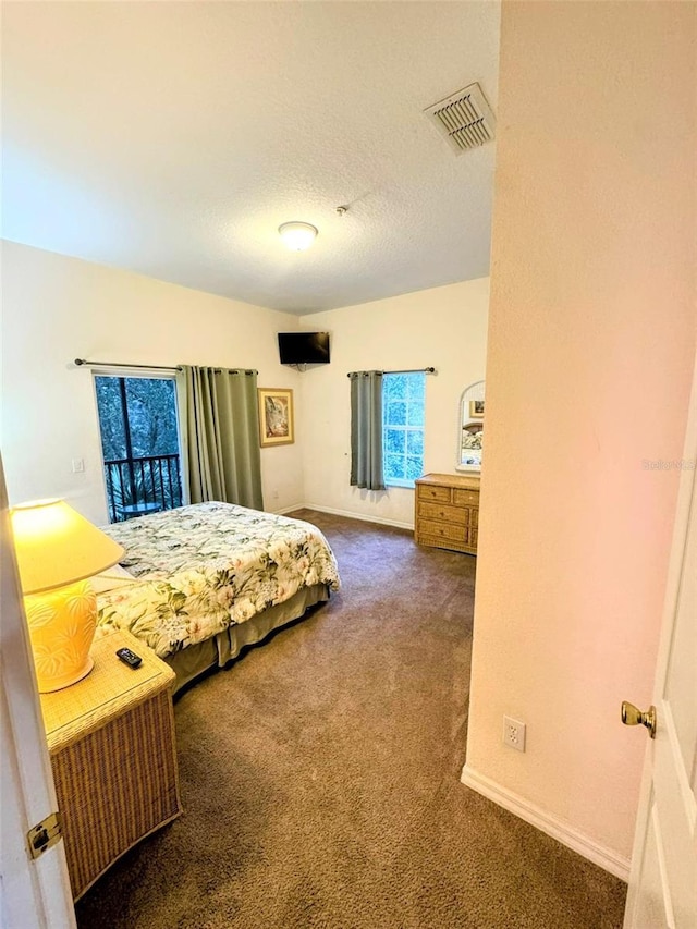 carpeted bedroom featuring a textured ceiling