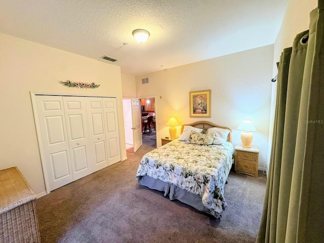 bedroom featuring carpet floors, a textured ceiling, and a closet