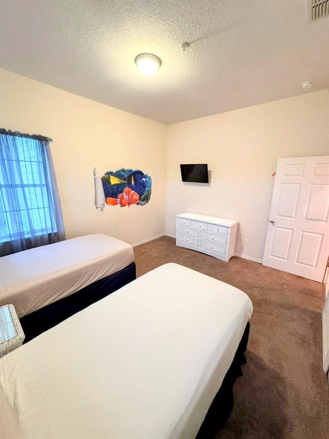 bedroom with carpet and a textured ceiling