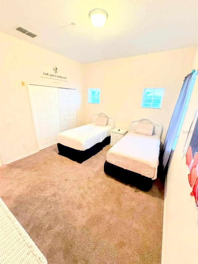 bedroom with carpet floors and a closet