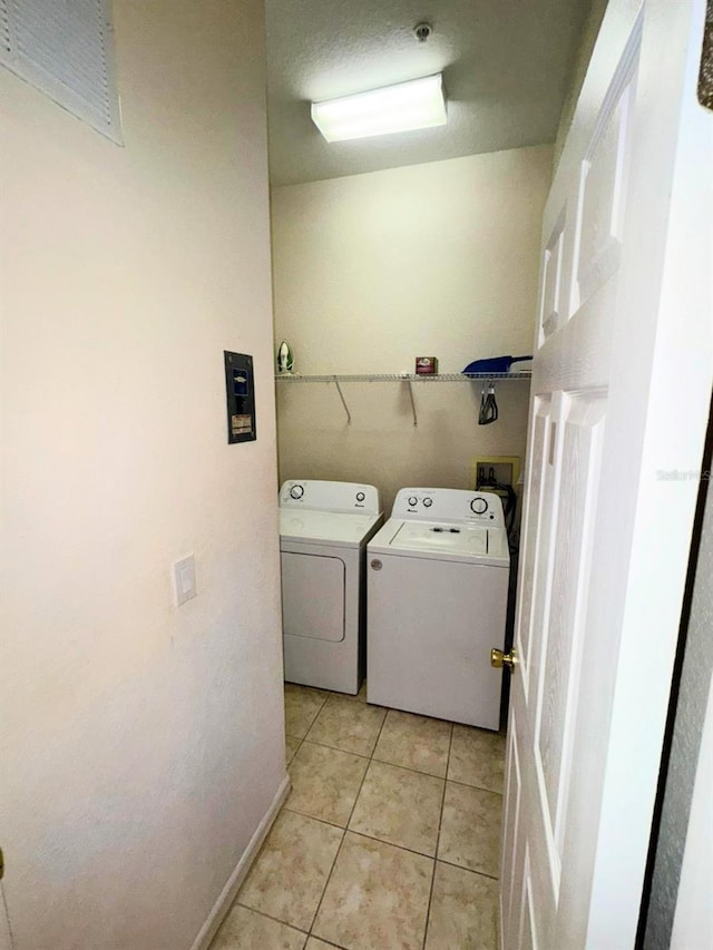 laundry area with light tile patterned flooring and independent washer and dryer