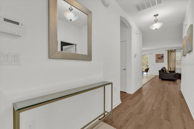 hallway with hardwood / wood-style floors