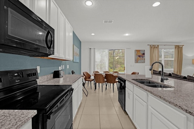 kitchen featuring sink, white cabinetry, plenty of natural light, and black appliances