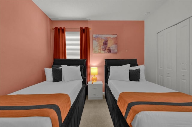 bedroom with light colored carpet and a closet