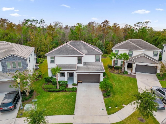 traditional-style house with a tile roof, concrete driveway, a front yard, stucco siding, and a garage