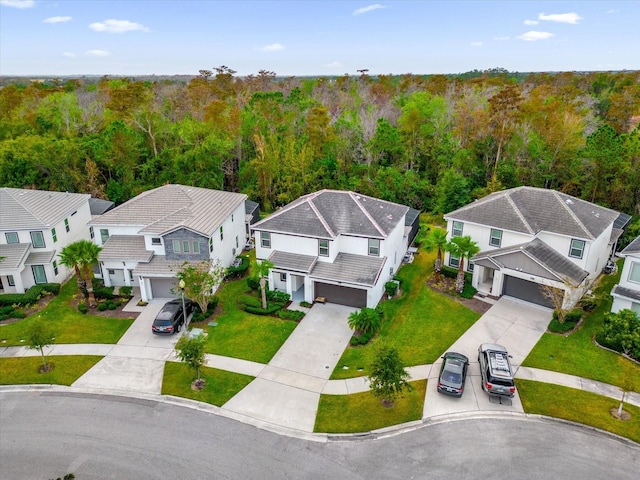 bird's eye view with a wooded view and a residential view