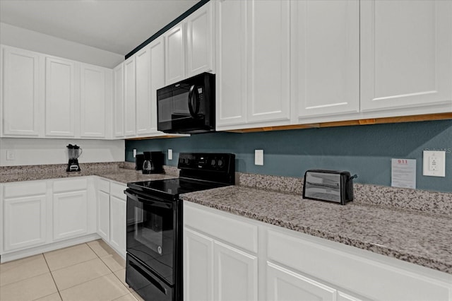 kitchen featuring light stone counters, black appliances, light tile patterned flooring, and white cabinetry