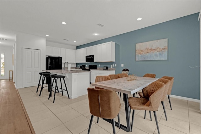 dining room featuring recessed lighting, baseboards, and light tile patterned floors