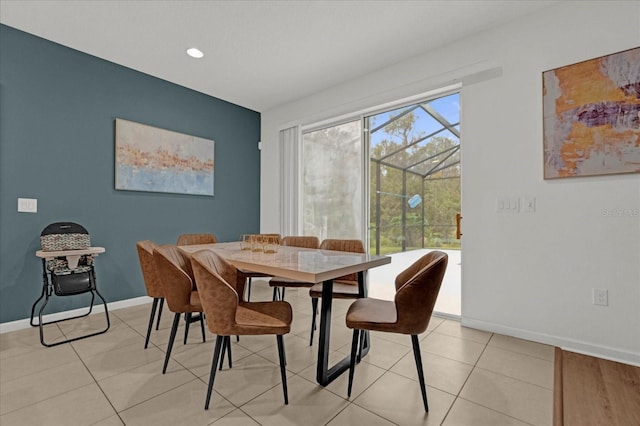 dining space with light tile patterned floors and baseboards