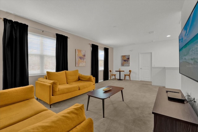 living room featuring baseboards, light carpet, and visible vents