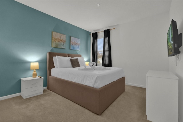 carpeted bedroom with baseboards