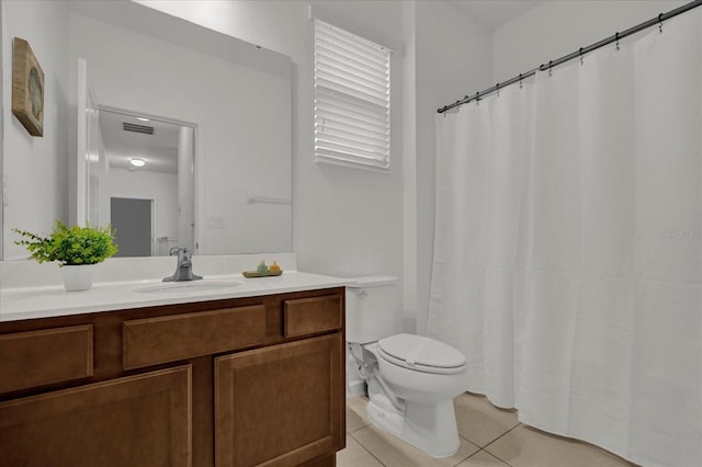 bathroom with visible vents, toilet, vanity, and tile patterned flooring