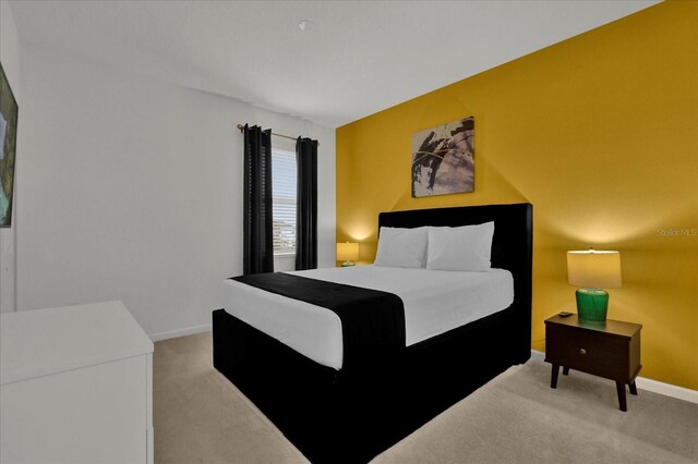carpeted bedroom with baseboards