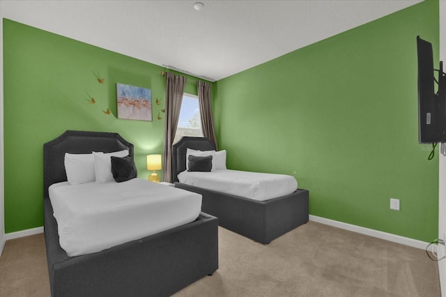 carpeted bedroom featuring baseboards