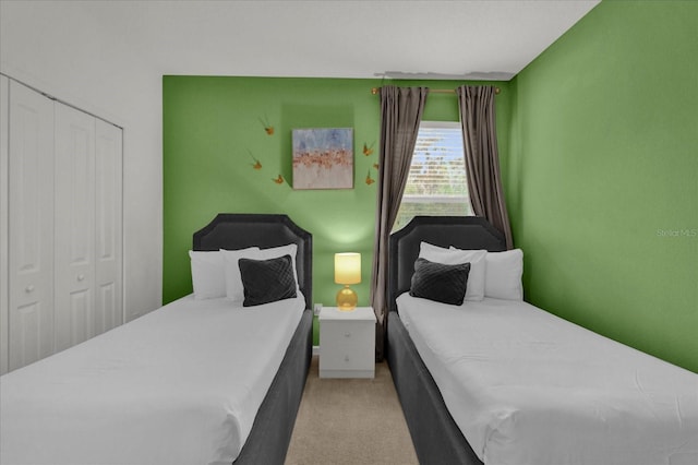 bedroom featuring a closet and light colored carpet