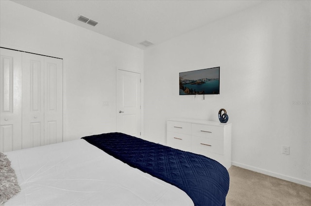 carpeted bedroom with visible vents, baseboards, and a closet