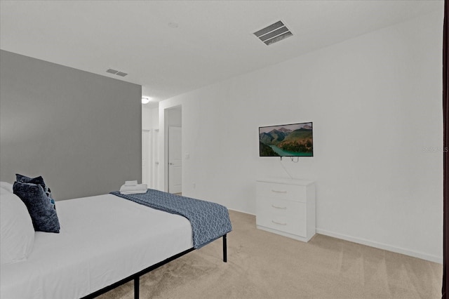 bedroom with visible vents and light colored carpet
