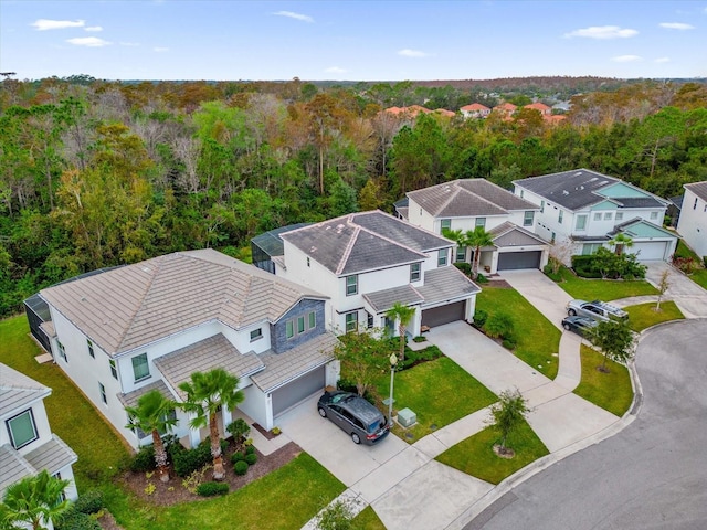 aerial view featuring a wooded view and a residential view