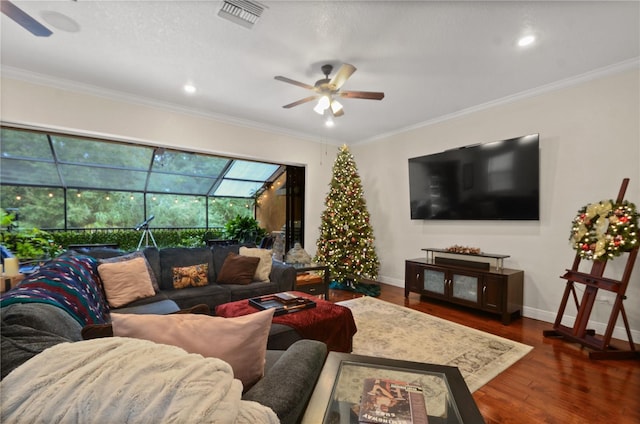 living room with ornamental molding, ceiling fan, and dark wood-type flooring