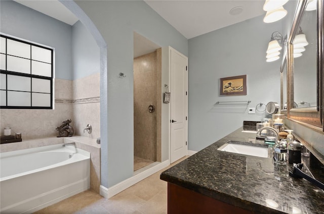 bathroom with tile patterned flooring, shower with separate bathtub, and vanity