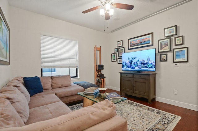 living room with ceiling fan and dark wood-type flooring