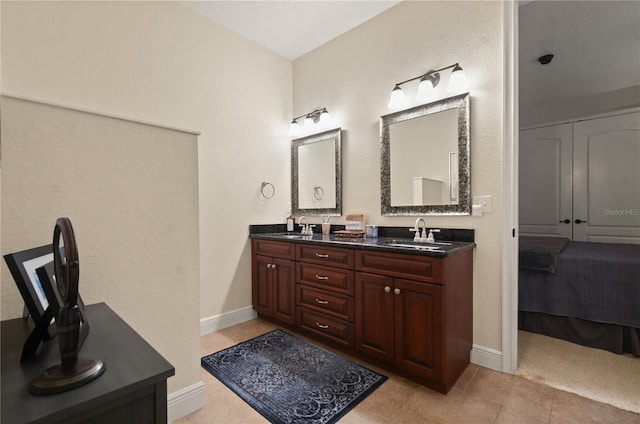 bathroom with tile patterned floors and vanity