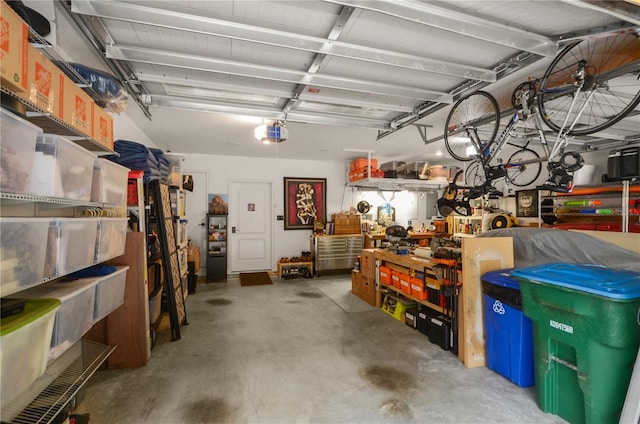 garage with a workshop area and a garage door opener