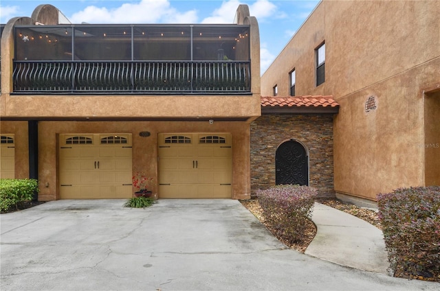 view of front of home with a garage and a balcony